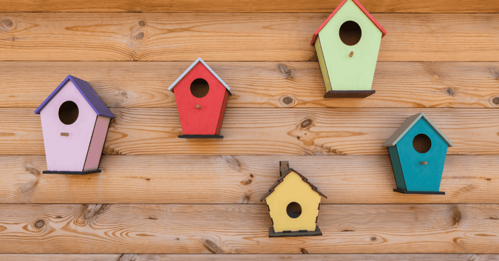 bright birdhouse colors blueish, purple green, red, orange on a wall